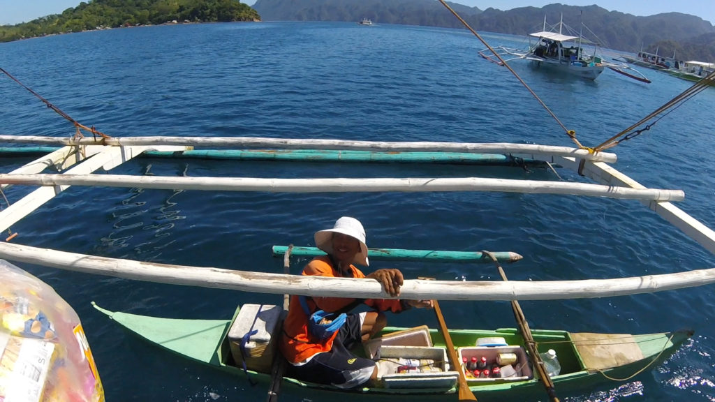 Man on 7=eleven boat on Coron Ultimate tour, Philippines