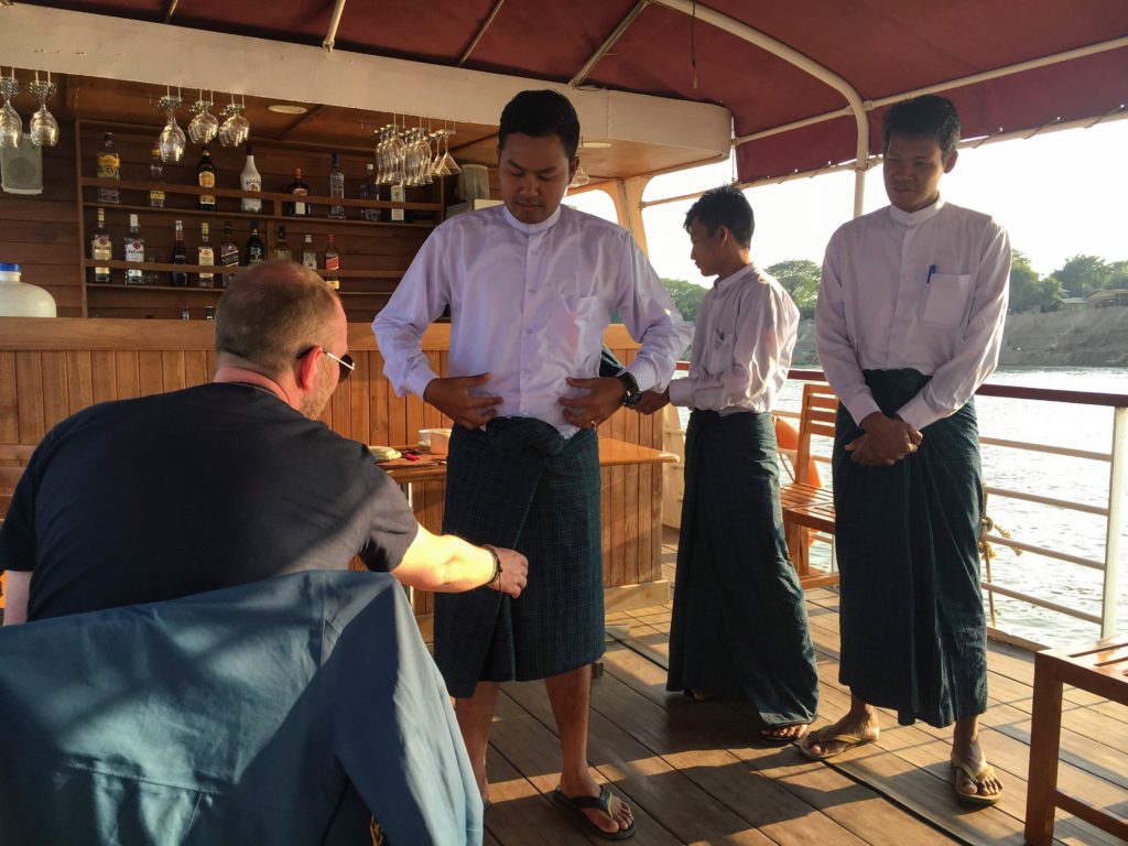 RV Panorama ferry from Bagan to Mandalay cultural demonstration how to tie a lungi